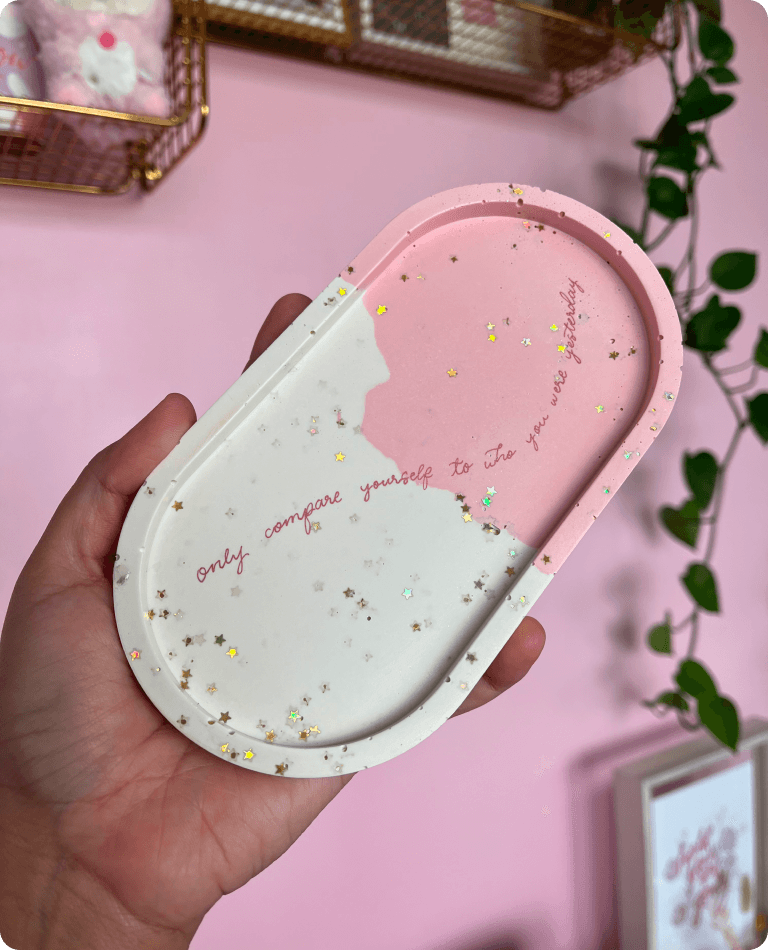 A picture of a large pink catchall with a handwritten message being held up